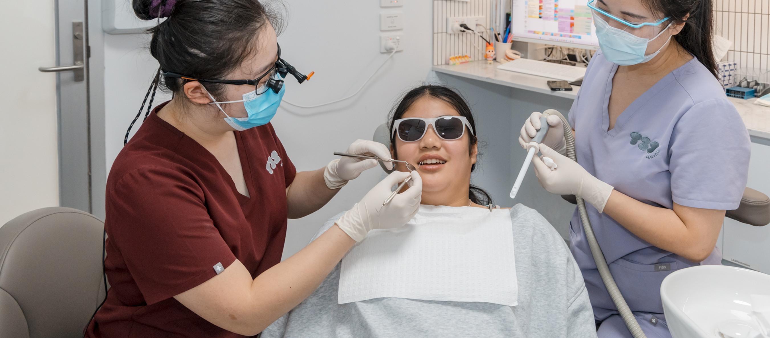 Dentists provide expert dental services to a patient at T32 Dental, performing a comprehensive dental treatment.