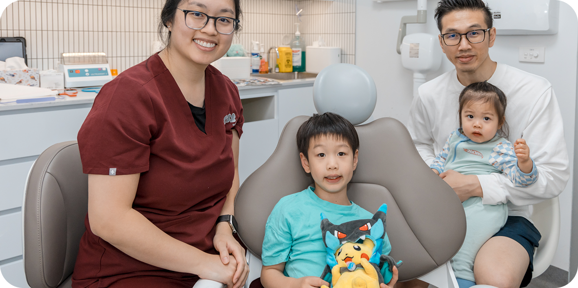 About T32 Dental: Health professional with a family, including a boy and baby, smiling in the modern clinic.
