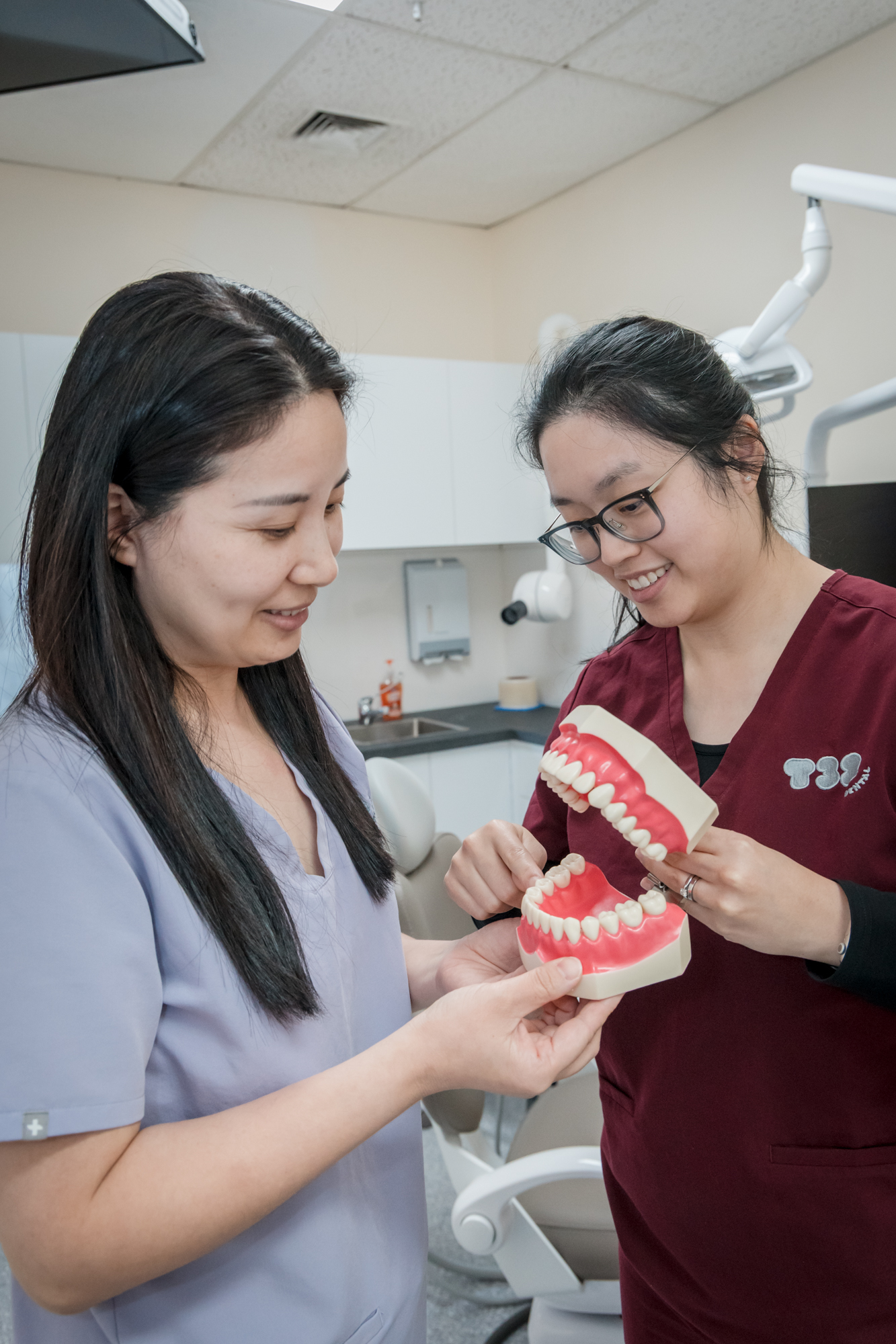 T32 Dental Wantirna's experienced dental team reviewing a tooth model for patient education.