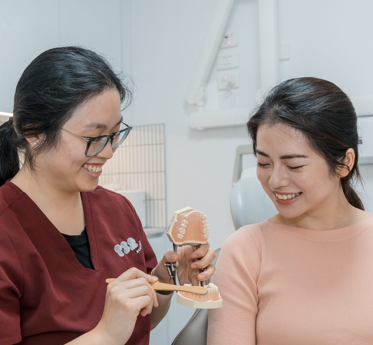 Dental professional educates a patient on oral hygiene, part of maintaining a healthy smile for teeth whitening.