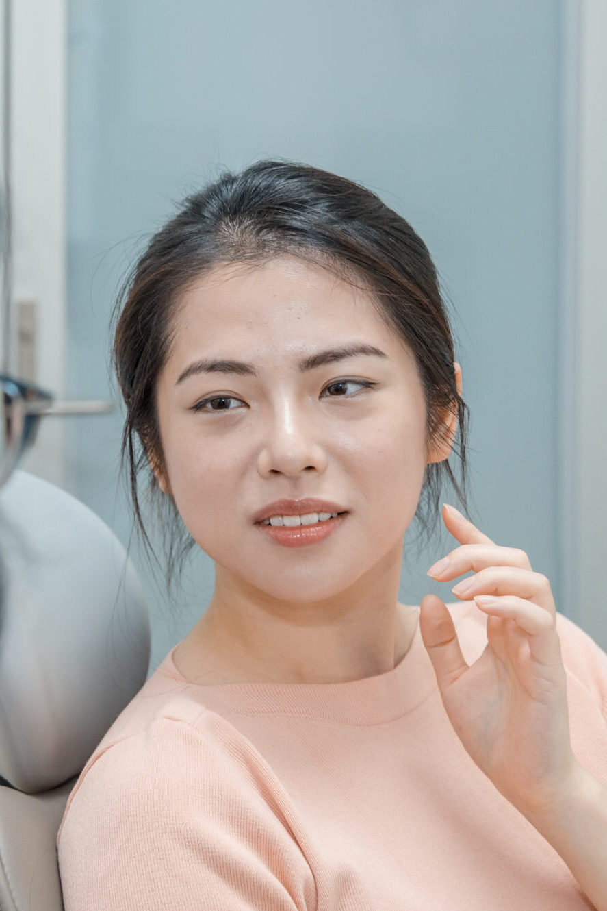 Patient in dental chair listening to advice about dental solutions like mouthguards.