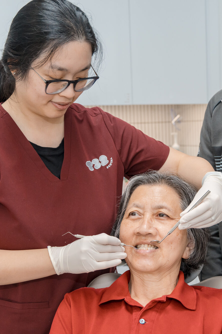 Dentist checking an older patient's oral health for signs of gum disease