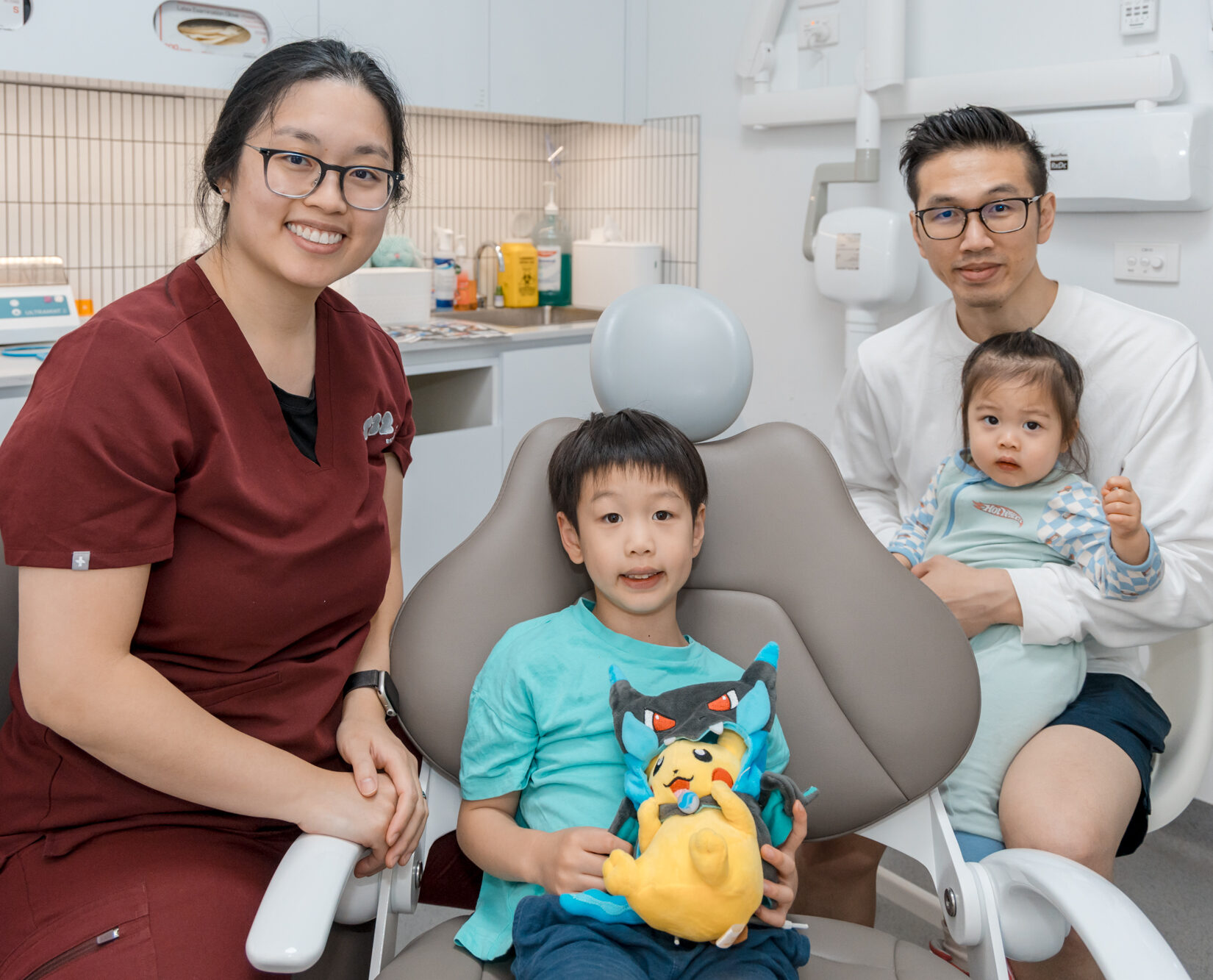 A friendly dentist and young patient showcase comfortable children-dentistry care in a welcoming clinic.