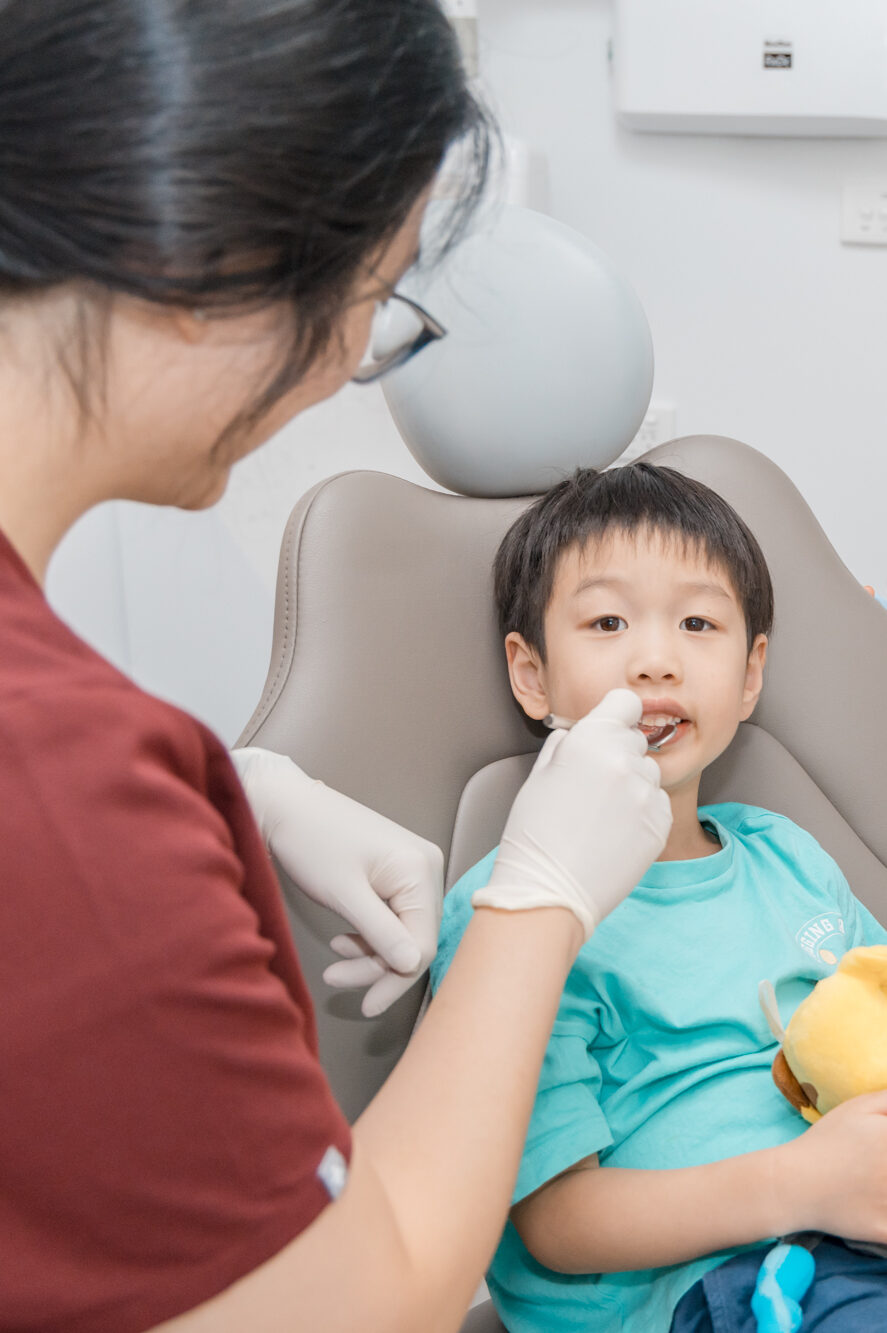 Pediatric dental exam highlighting early tooth care that helps prevent tooth loss and the eventual need for dentures.