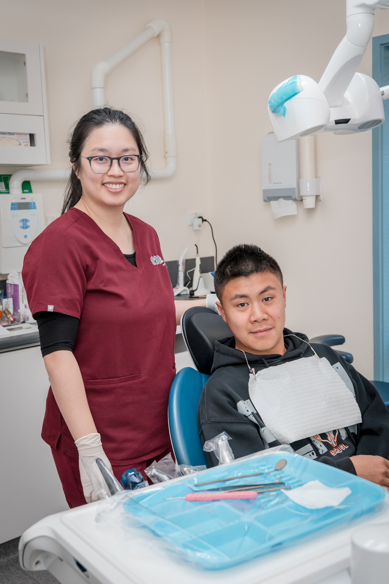 A health professional and patient in a dental clinic, discussing potential treatments for gum disease.