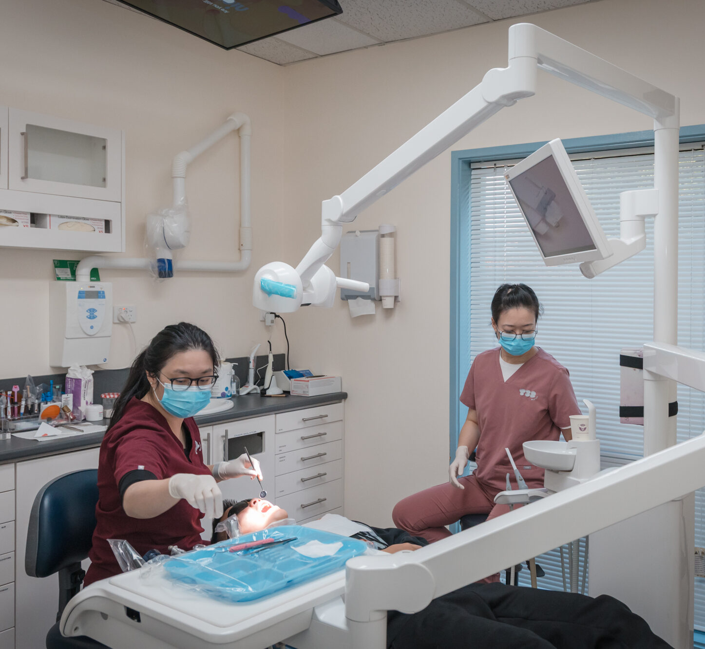 Dentist preparing a patient for a wisdom teeth removal procedure in a modern dental clinic.