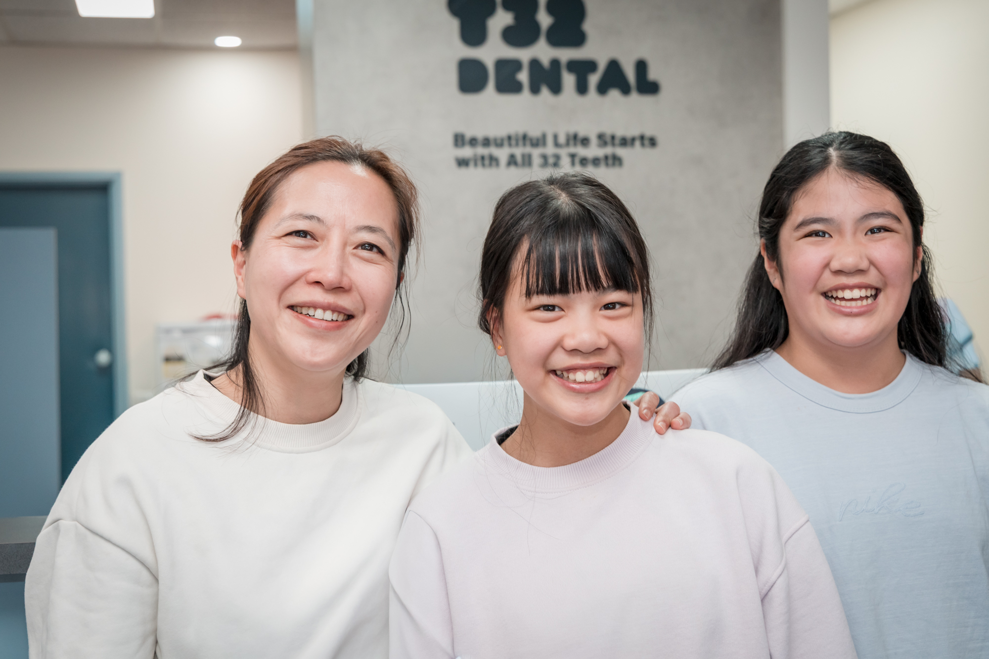 Happy smiles from three individuals, showcasing bright teeth after teeth whitening.