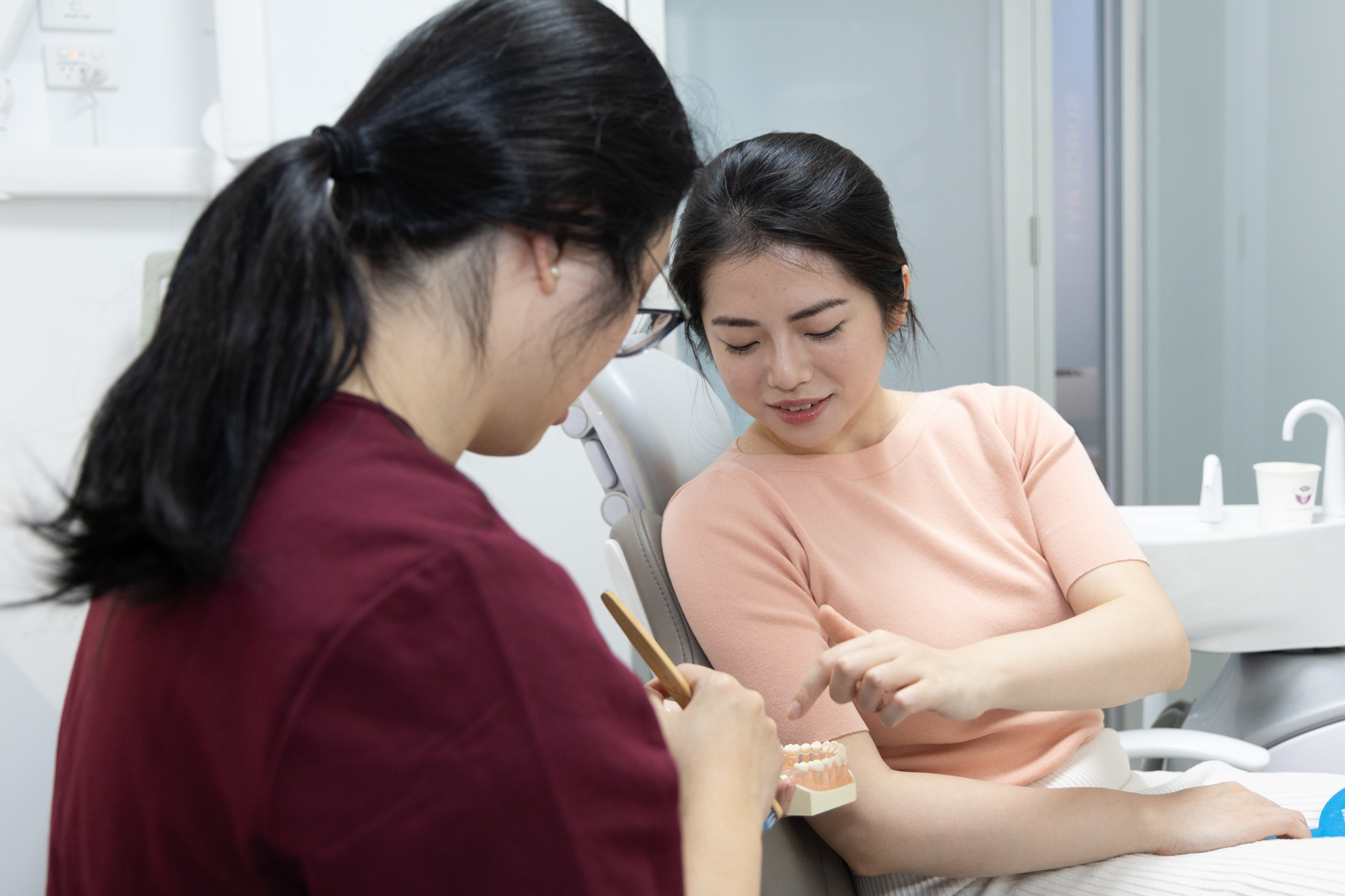 Consultation for dental implants with a patient and dentist discussing the procedure.