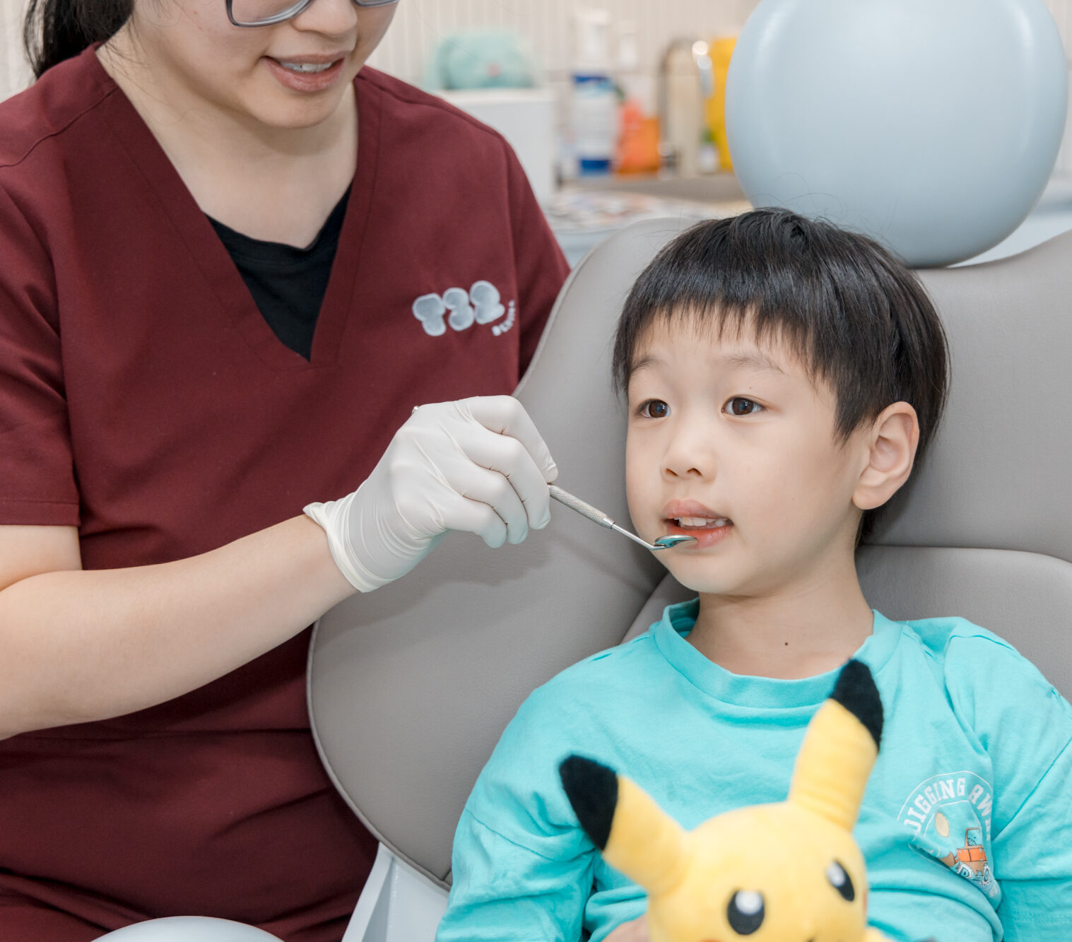 Child receiving a dental checkup to assess teeth for pediatric crown and bridges treatments at a dental clinic.