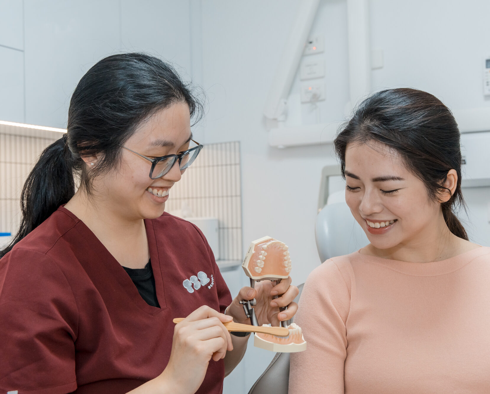 Educating an orthodontics patient on optimal tooth and gum care during their treatment plan.